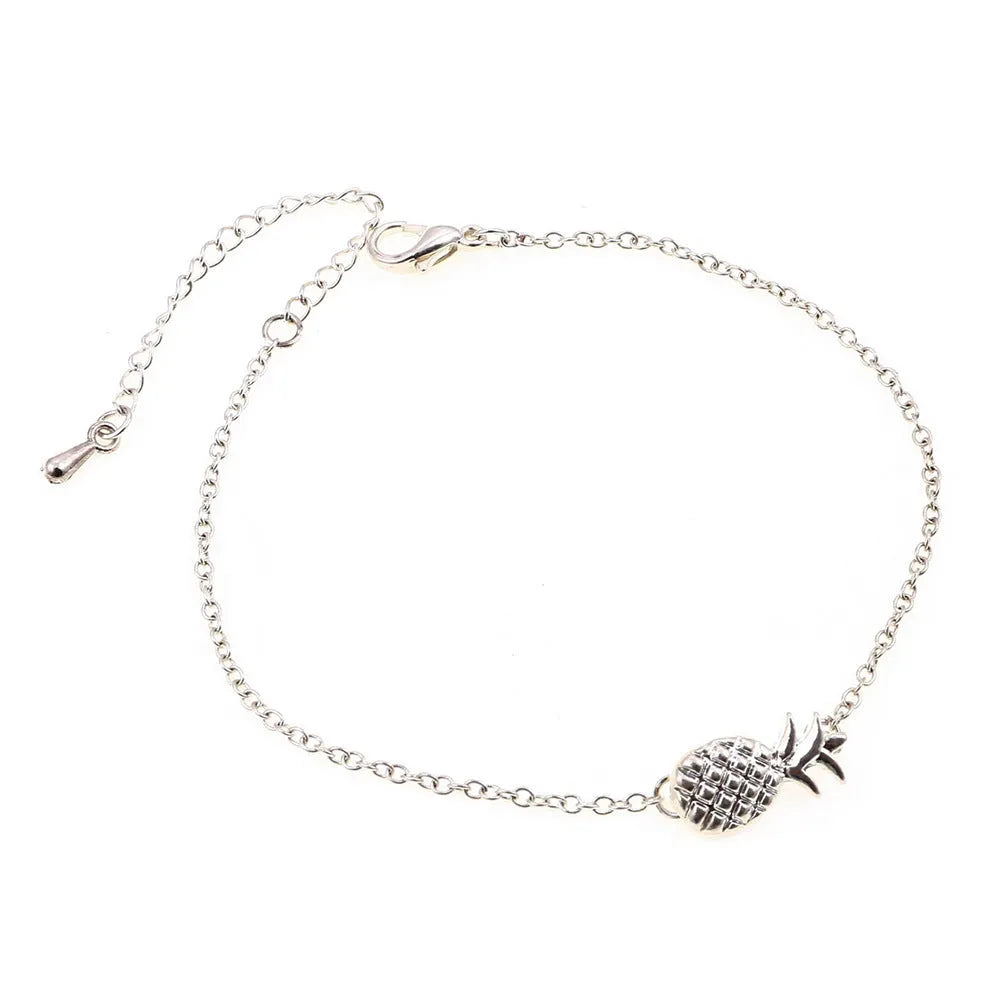 Gold and silver alloy bracelet with a pineapple charm on an adjustable band.