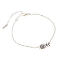 Gold and silver alloy bracelet with a pineapple charm on an adjustable band.