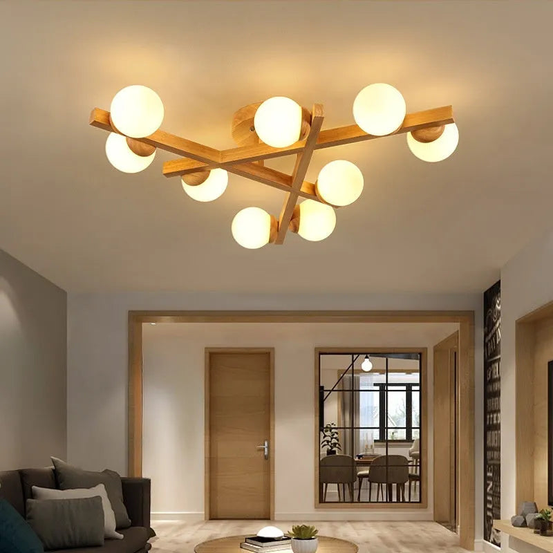 Modern black and copper three-headed pendant ceiling light with adjustable arms hanging over a wooden table