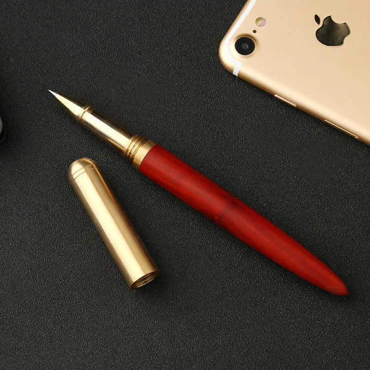 Brass and solid wood signature pen showing wood grain and metallic details.