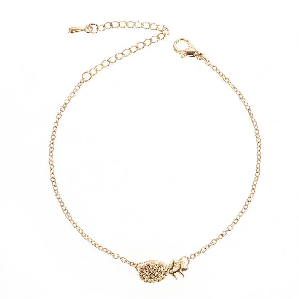 Gold and silver alloy bracelet with a pineapple charm on an adjustable band.