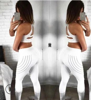 Women's black workout leggings with glowing white print pattern, showing slimming pencil pants fit.