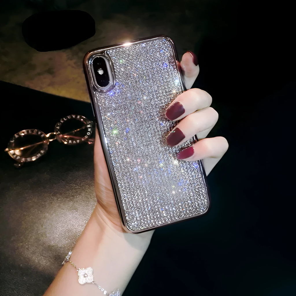 Silver full diamond glitter silicone protective case for iPhone on a table.