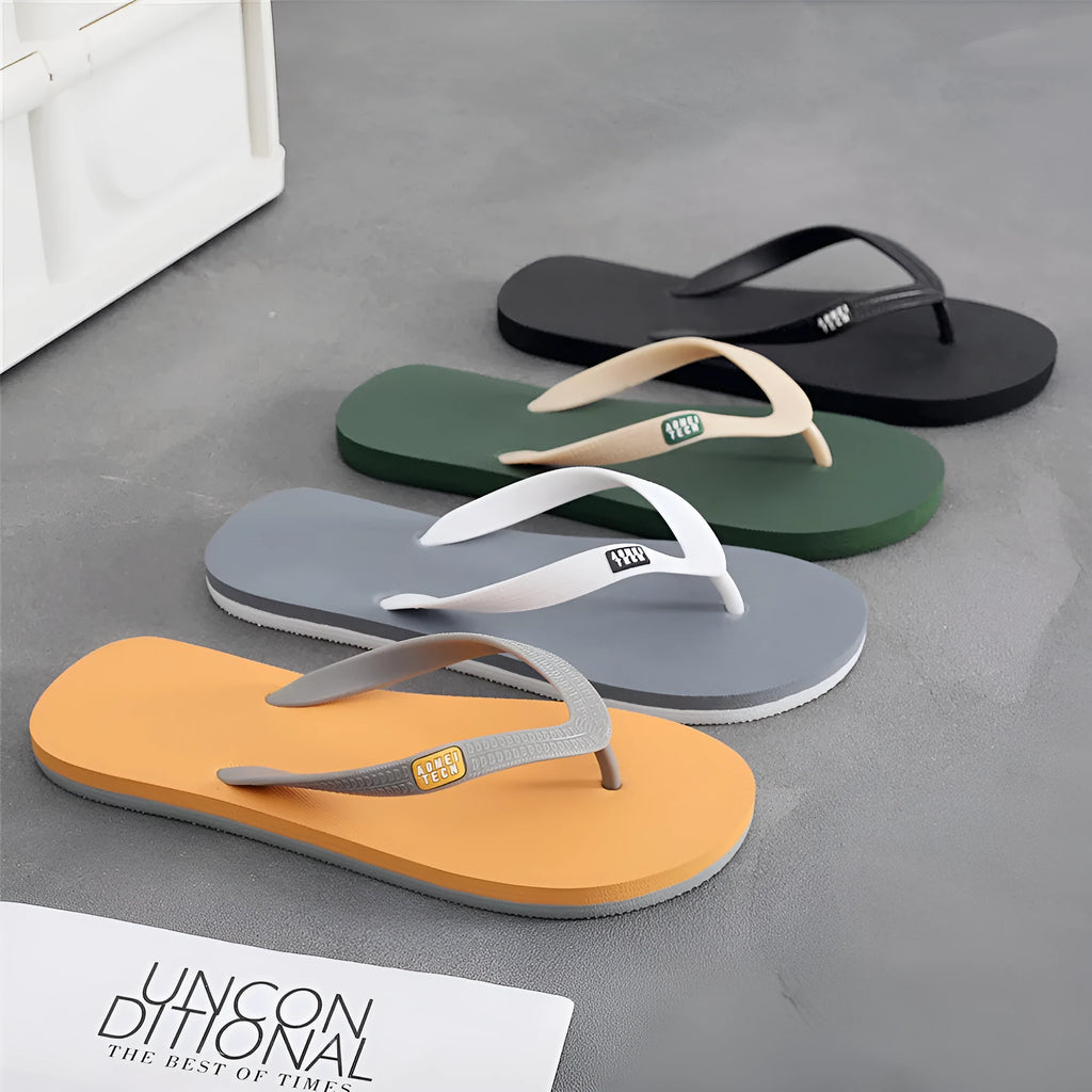 Men's black rubber sole flip-flops with an EVA foam upper on a wooden deck