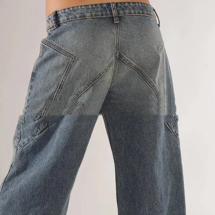 Blue loose straight wide leg cotton trousers with low waist and stitching detail on a model.