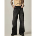 A pair of black loose-fit straight-leg jeans with a retro style on a white background.