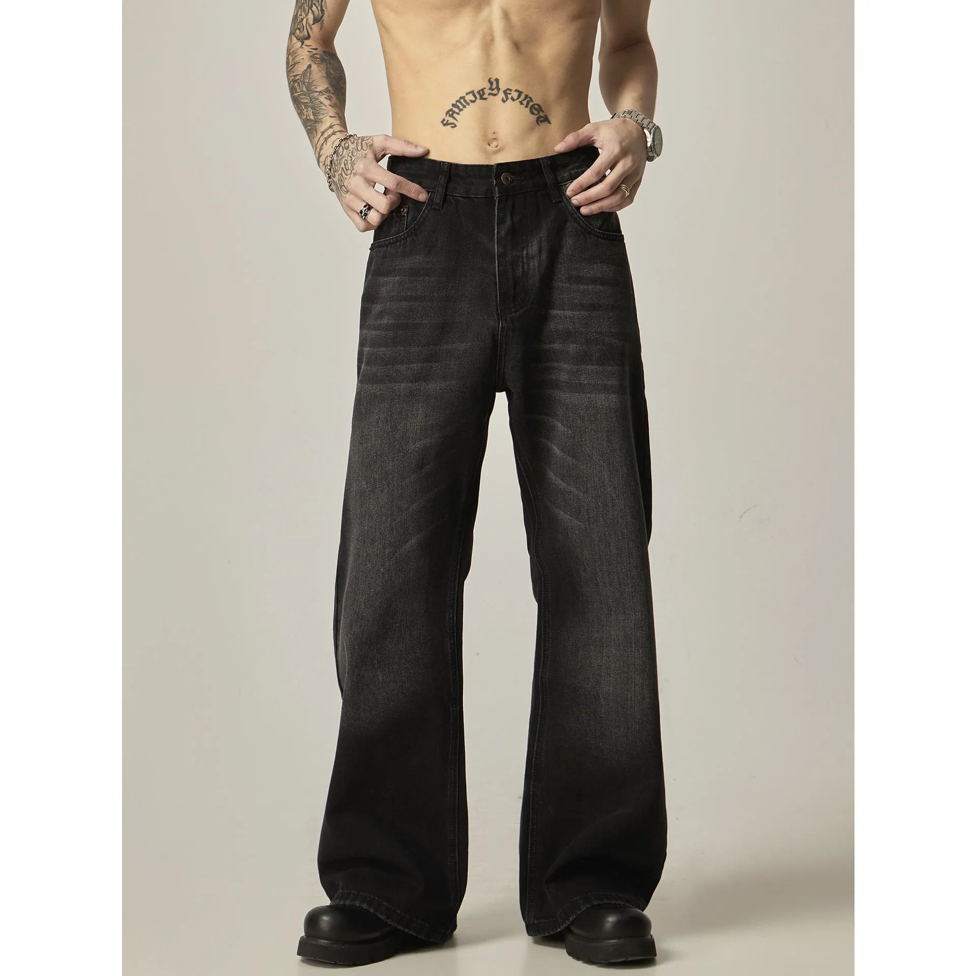 A pair of black loose-fit straight-leg jeans with a retro style on a white background.