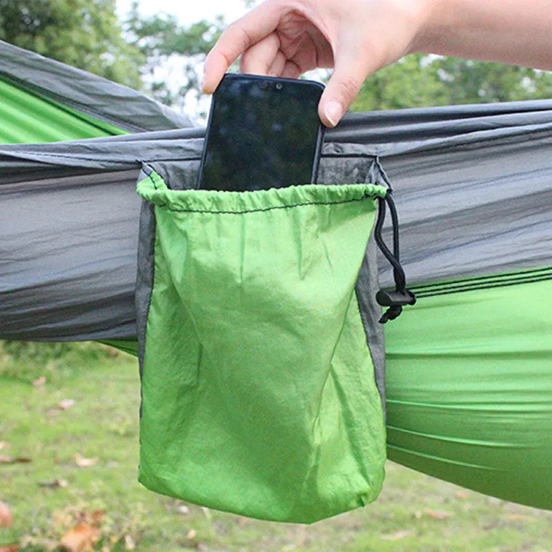 A sapphire blue double-layer nylon hammock hung between two trees, showing its full 270cm length and 140cm width.