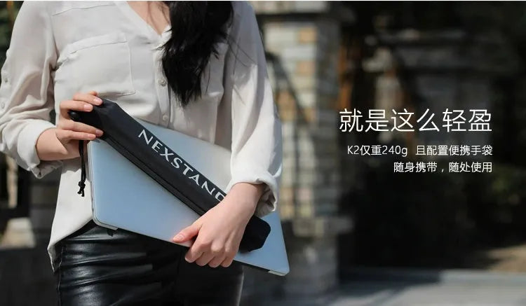 Black foldable enhanced nylon laptop stand shown open next to its portable carry bag.