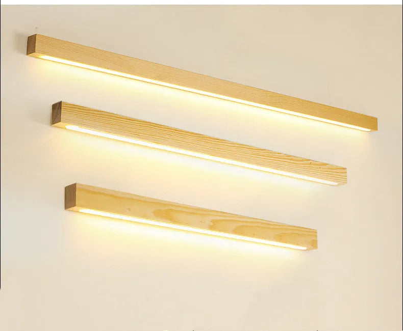 Walnut-coloured wooden log strip wall lamp with acrylic elements and integrated LED lighting.