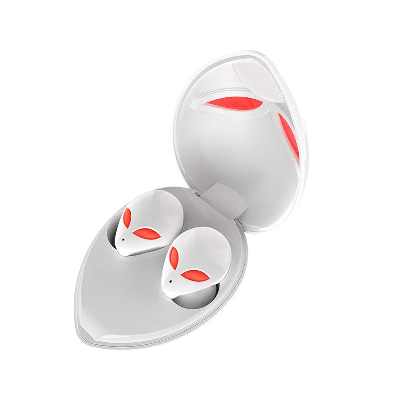 Creative Outer T8 Starman alien-shaped Bluetooth earbuds with LED lights next to their wireless charging case.