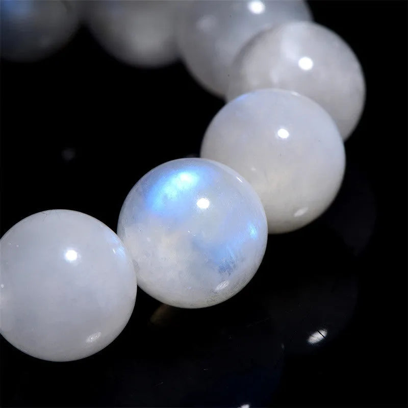 Natural blue moonlight round bead moonstone bracelet on a white background, showing polished geometric beads.