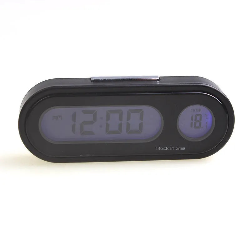 Black digital LED car clock and thermometer with adjustable mounting bracket on a dashboard.