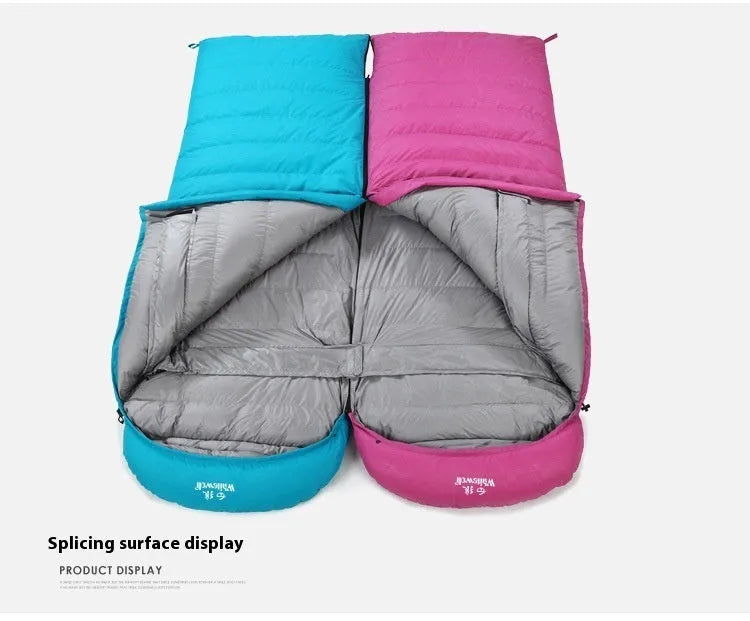 Black outdoor sleeping bag with thick goose down fill on a grassy campsite.