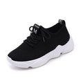 Women's white thick-soled sports shoe with woven upper and front strap