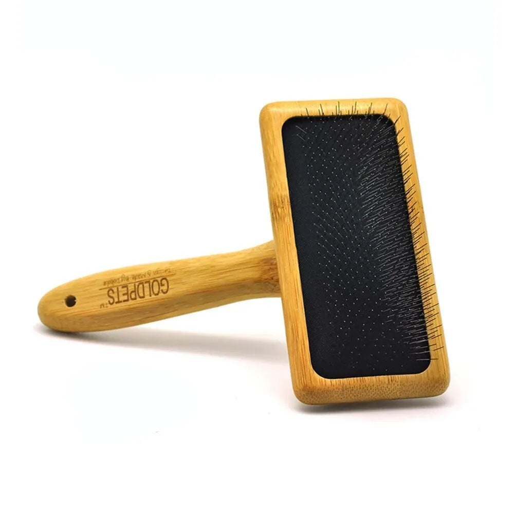 Goldpets bamboo and wood slicker brush for pets with stainless steel pins on a wooden handle.