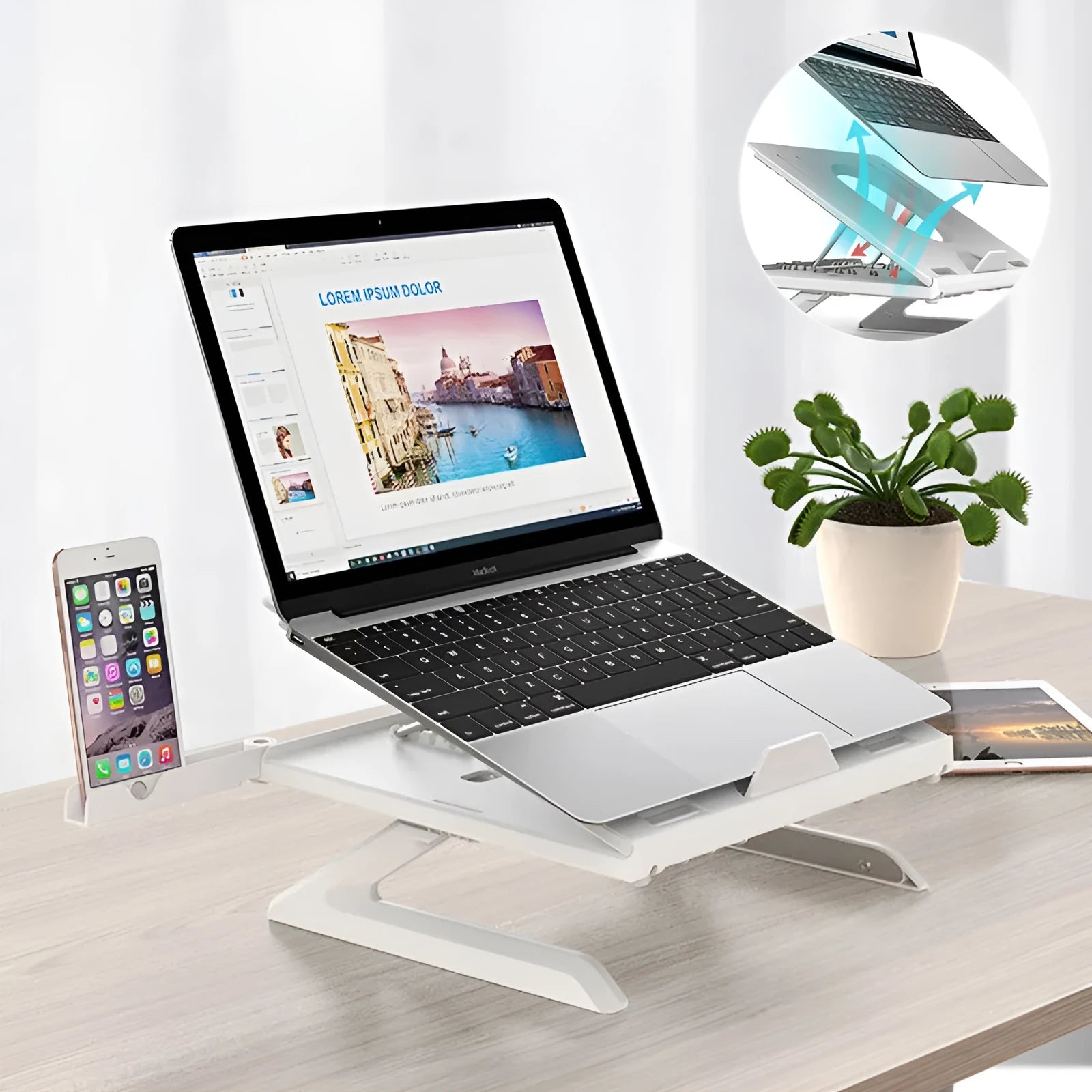 Black folding aluminium laptop stand with 9-level angle adjustment and cooling slot, on a desk with a laptop