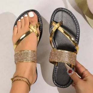 Women's beach sandals with rhinestone toe strap and flat rubber soles in black, gold, and silver colours