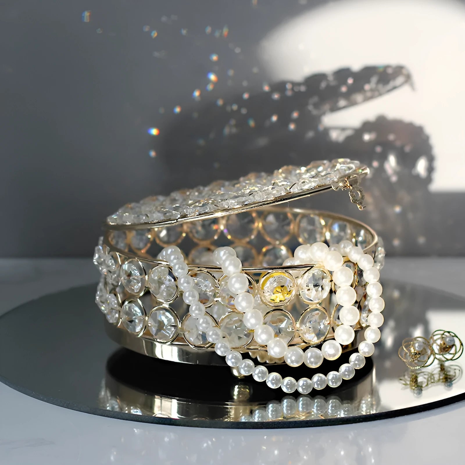 Transparent crystal glass jewelry box with a French gold metal frame in a European style.