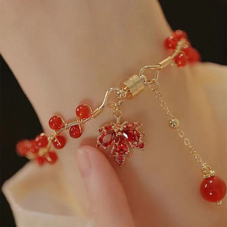 Red ginkgo leaf charm on an alloy magnetic bracelet in a Chinese style.