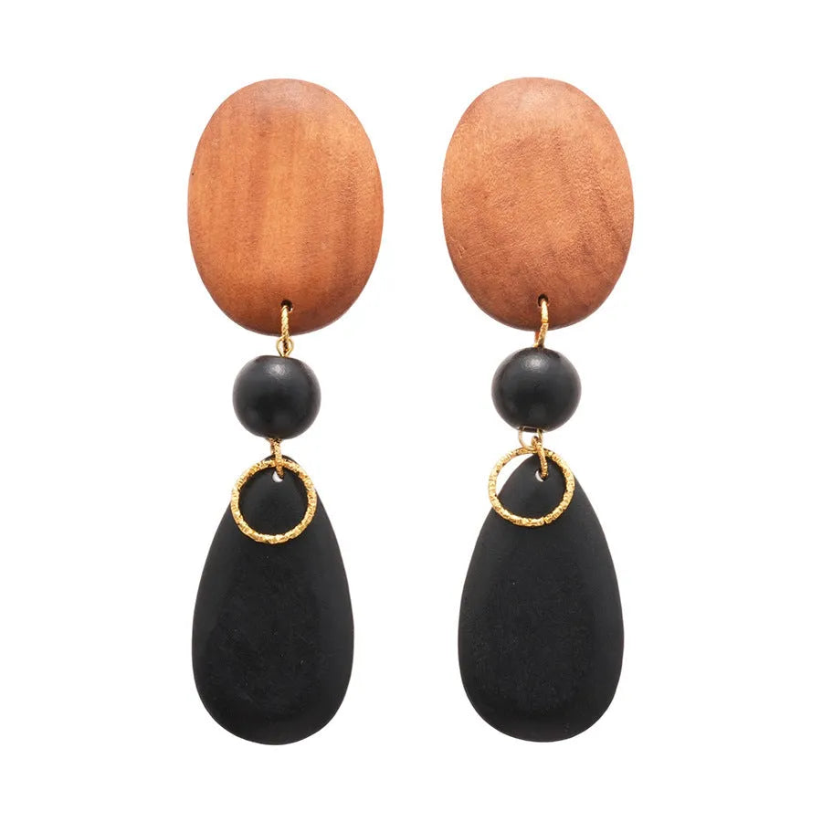 Pair of brown and black wooden retro earrings with an elliptical shape and silver needle detail.