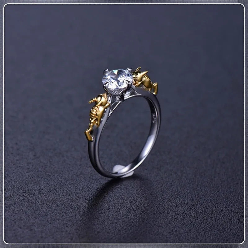Close-up of a black gold copper ring with a detailed three-dimensional crown design on a finger.