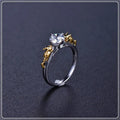 Close-up of a black gold copper ring with a detailed three-dimensional crown design on a finger.