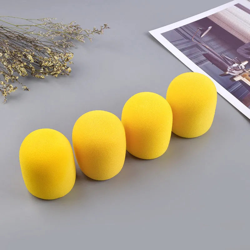 Four multicoloured foam microphone windshields for handheld stage microphones
