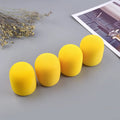 Four multicoloured foam microphone windshields for handheld stage microphones