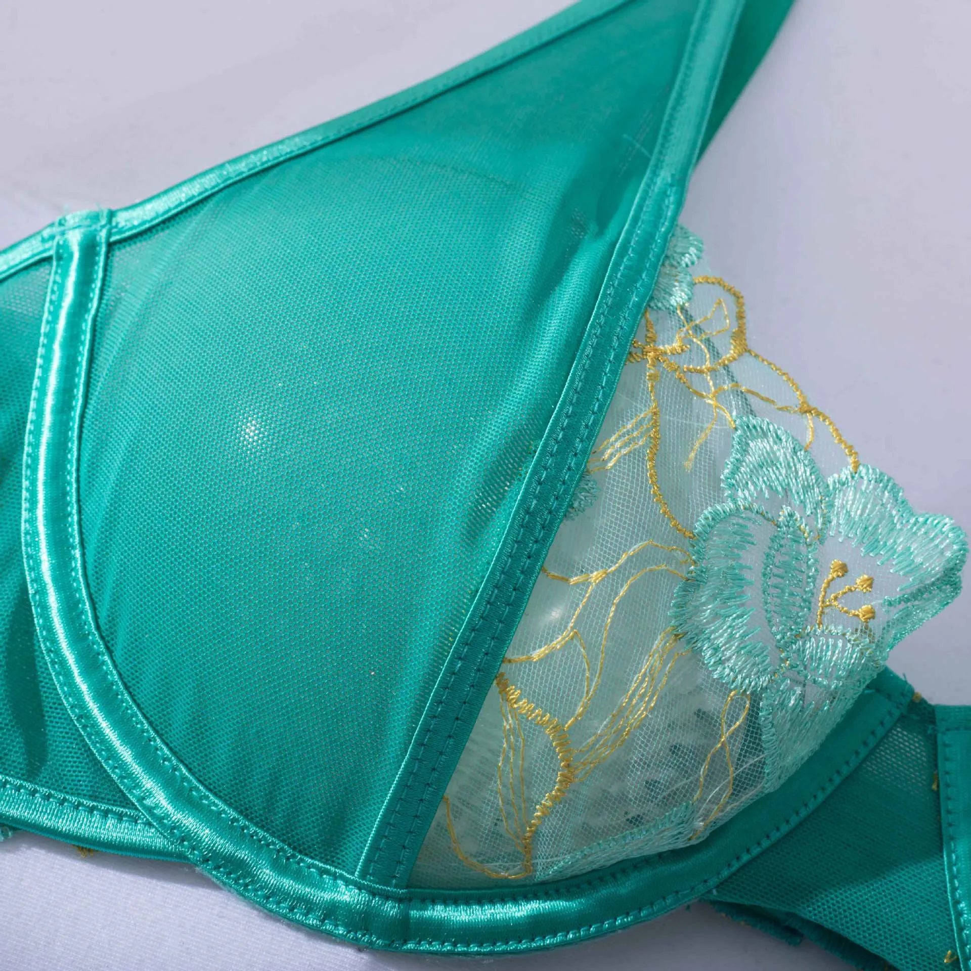 Light green women's bra set with embroidery detailing and matching bikini bottoms.