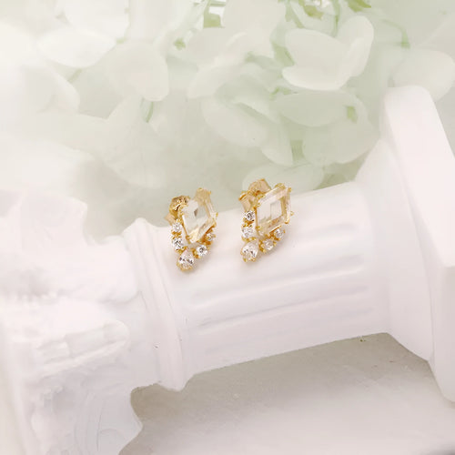 Geometric 925 silver ear studs with natural white crystal accents on simple background