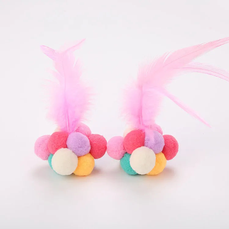 Cat toy feather bouncy ball with colourful pink feathers and blue white feathers for interactive play