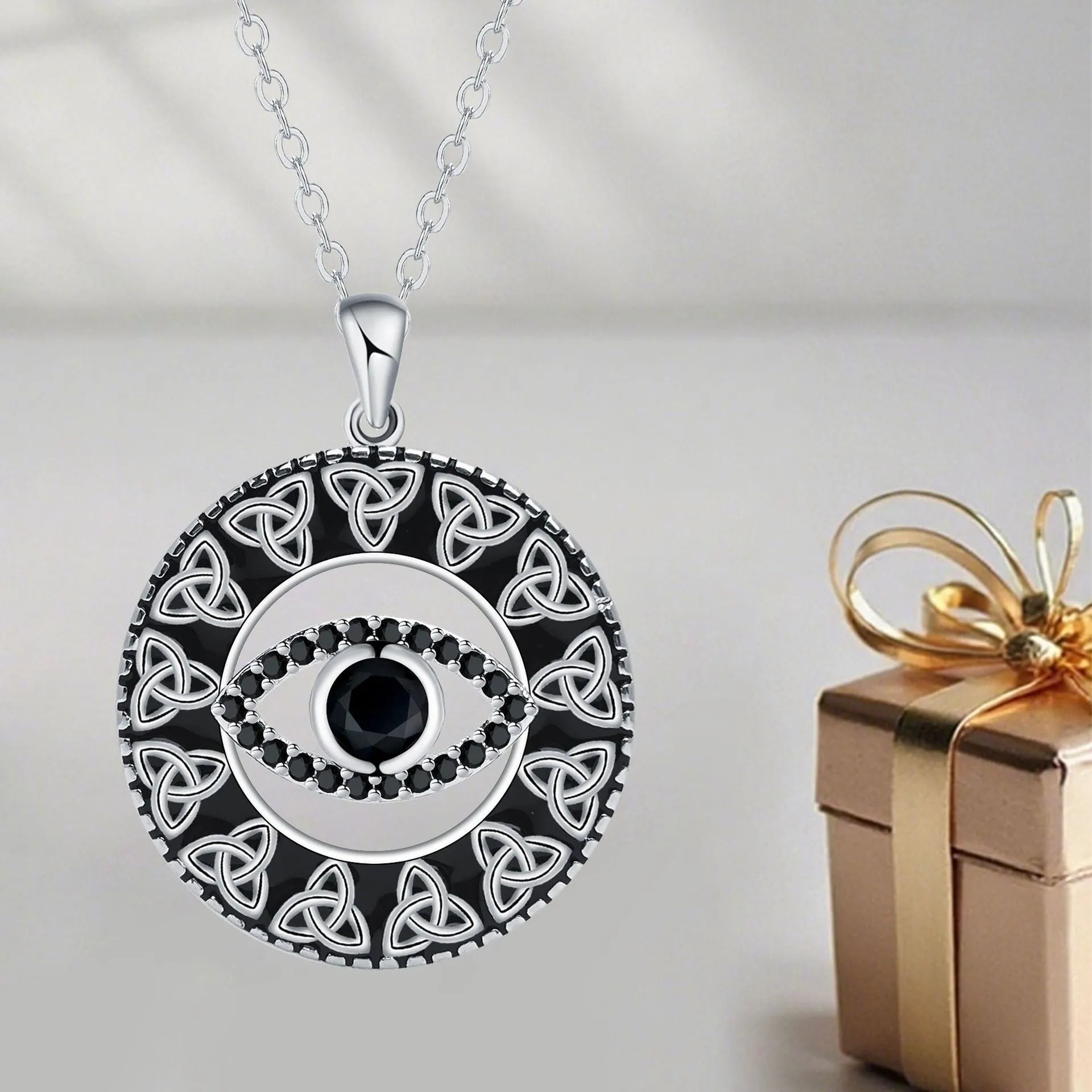 Copper devil's eye pendant necklace with a cross chain for women.