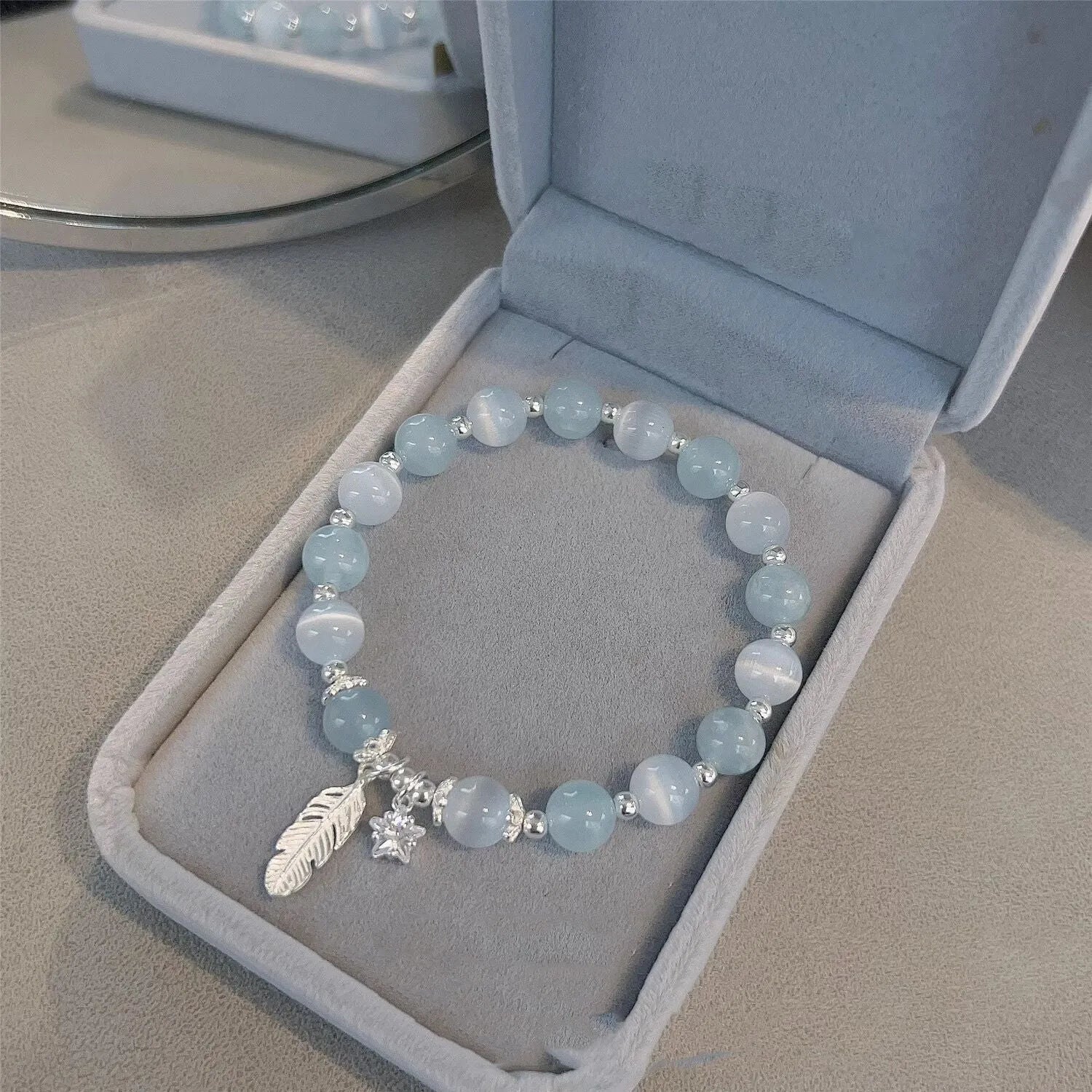 Korean style glass and coloured glaze crystal bracelet in feather XINGX blue moonlight colour with text detailing