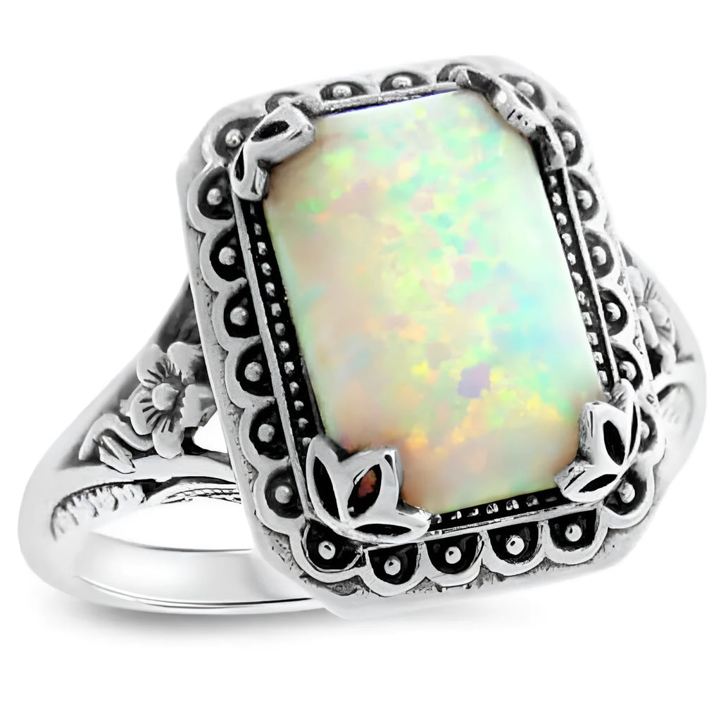 Silver alloy geometric ring with inlaid opal stone on a white background