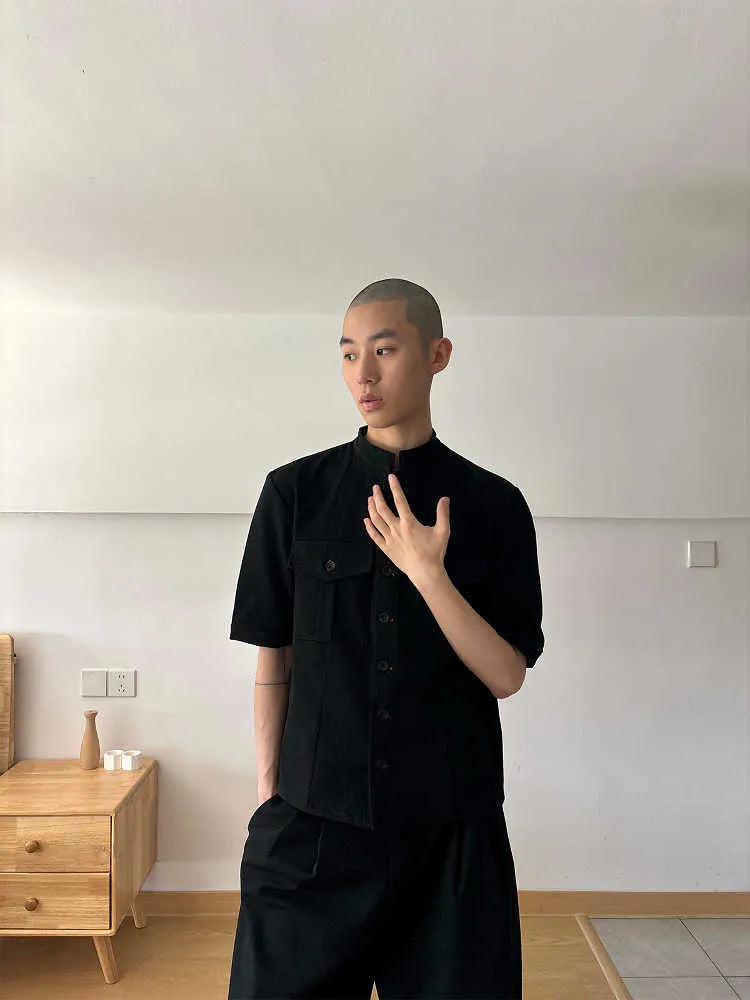 Black loose-fit half-sleeve hunting shirt with a shirt collar on a hanger.