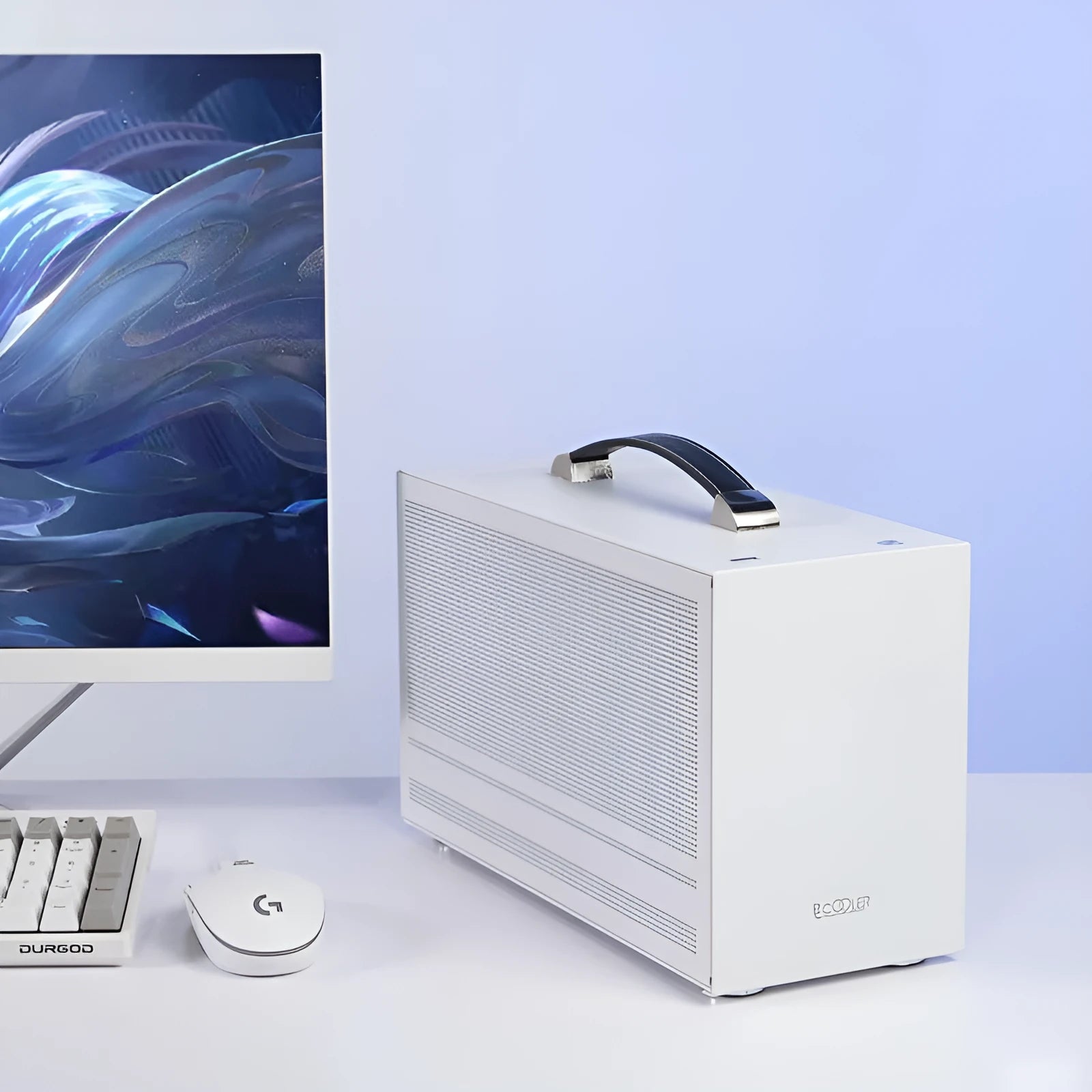 Three Hummingbird PRO titanium grey mini-ITX desktop computer case on a wooden desk
