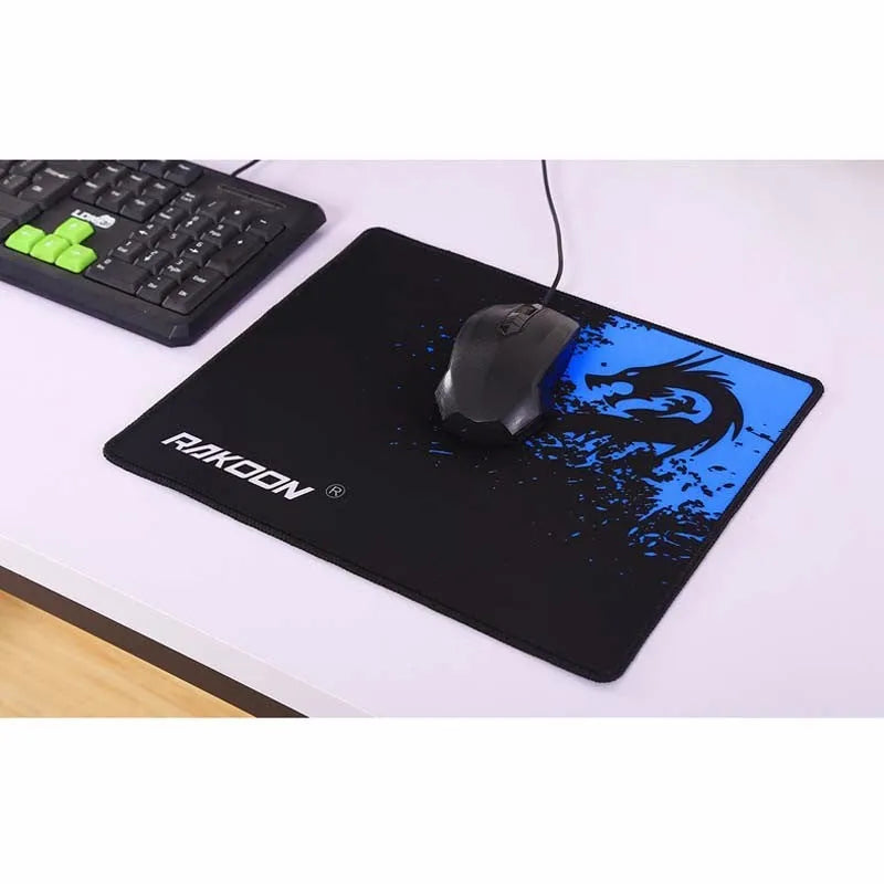 Mouse pad with textured surface and reinforced stitching edges on a desk