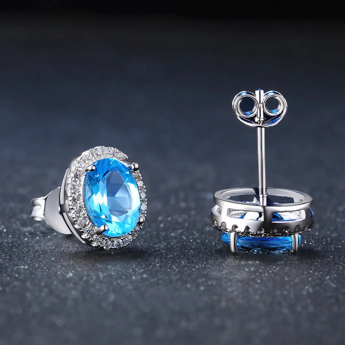 Geometric design women's sterling silver and blue topaz jewellery set showing earrings, ring, pendant, and necklace.