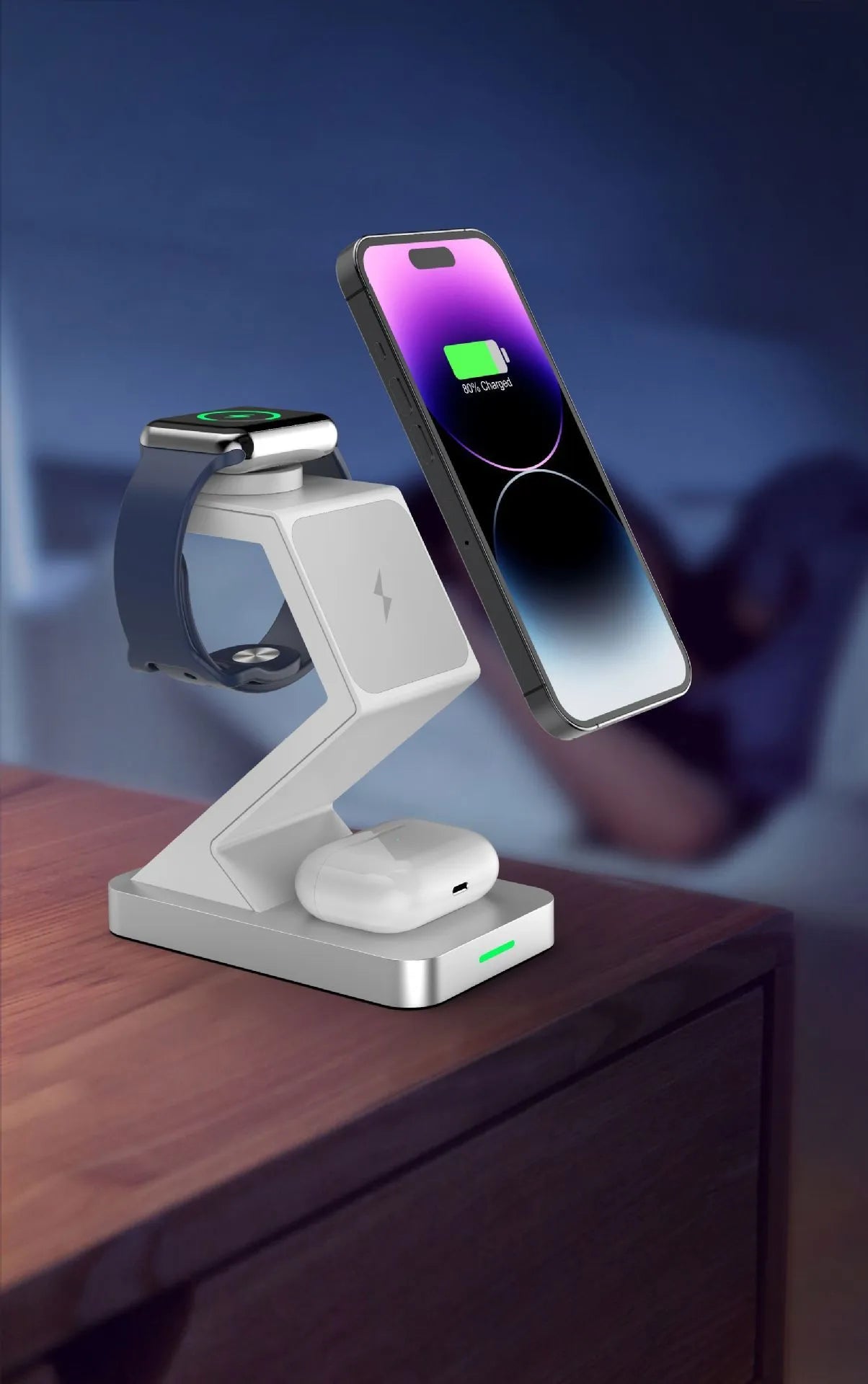 Three-in-one magnetic wireless charger phone holder in black with phone, watch and earbuds on a desktop