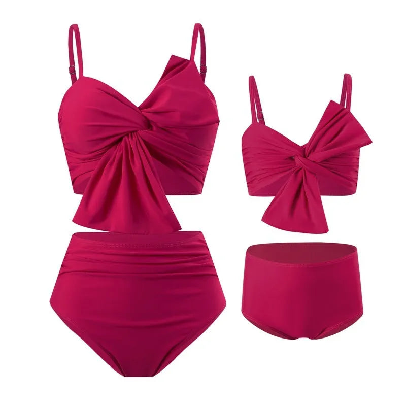 Women's big bow bikini and swim trunks set in a colourful print, shown in orange colour.