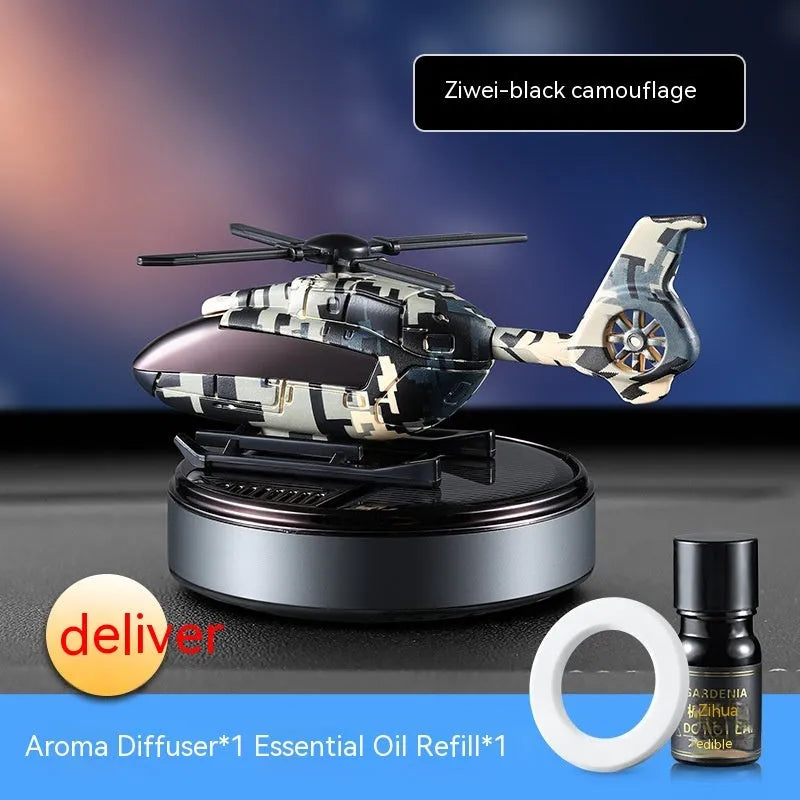 Solar-powered camouflage design car perfume and decoration unit on a car dashboard.