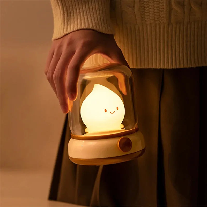 Green retro USB rechargeable desk lamp with adjustable knob on wooden table