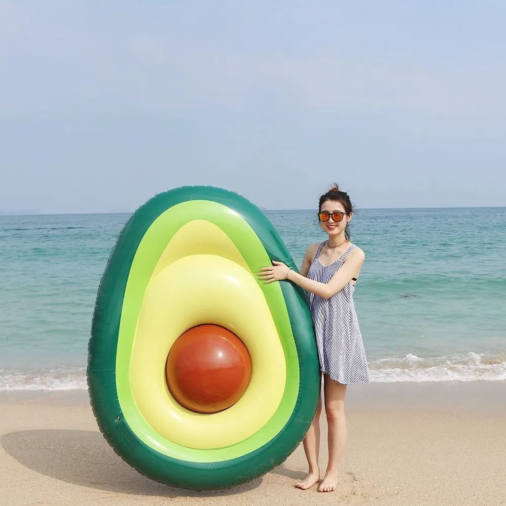 Green avocado-shaped inflatable pool float measuring 169cm long on blue water