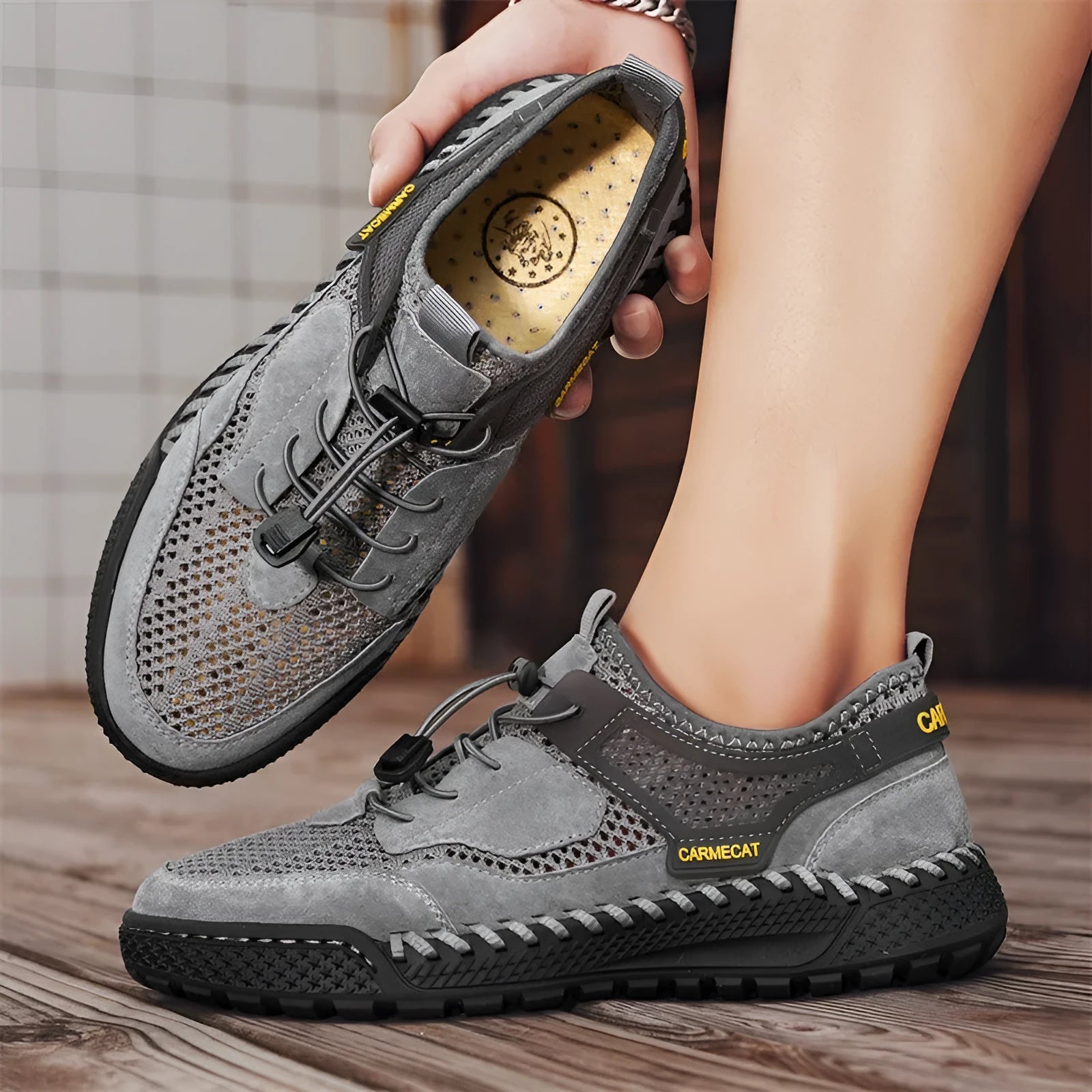 Men's brown suede casual shoes with elastic band closure and hand-stitched sole.
