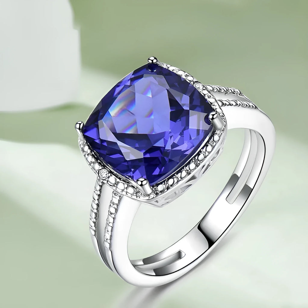 Women's sterling silver ring with a blue tanzanite gemstone on a silver band.