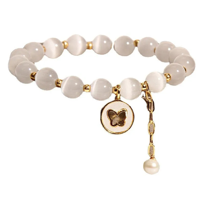 White geometric Cat's Eye crystal bracelet on a wrist, showing its handcrafted Korean-style design.
