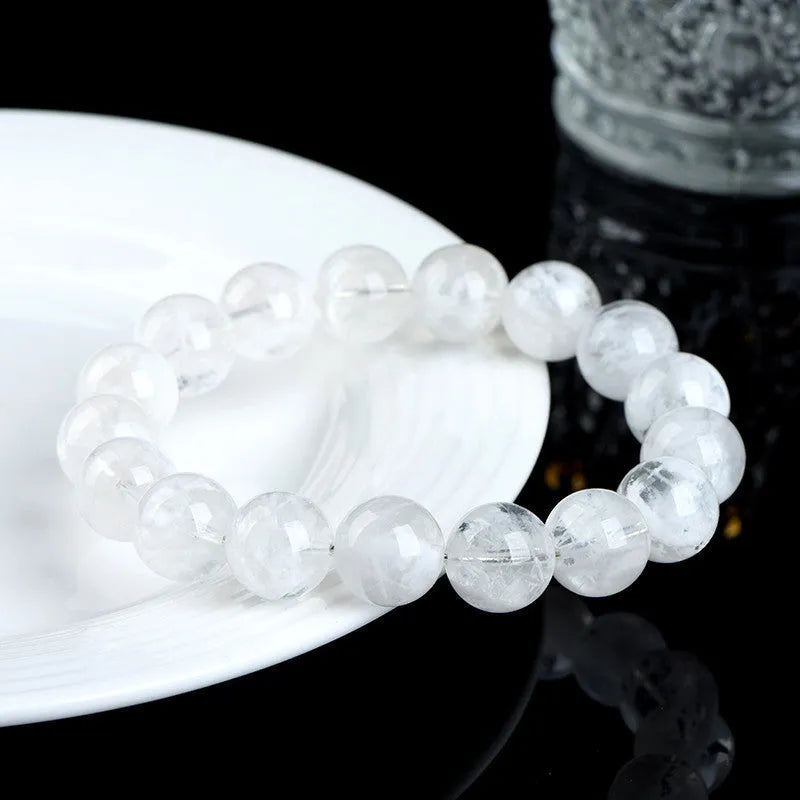 Women's bracelet with round blizzard snowflake crystal beads in geometric shapes on a wrist.