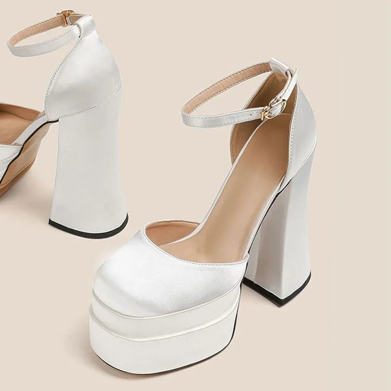 Women's white platform high heels with a chunky heel and round toe on a plain background.