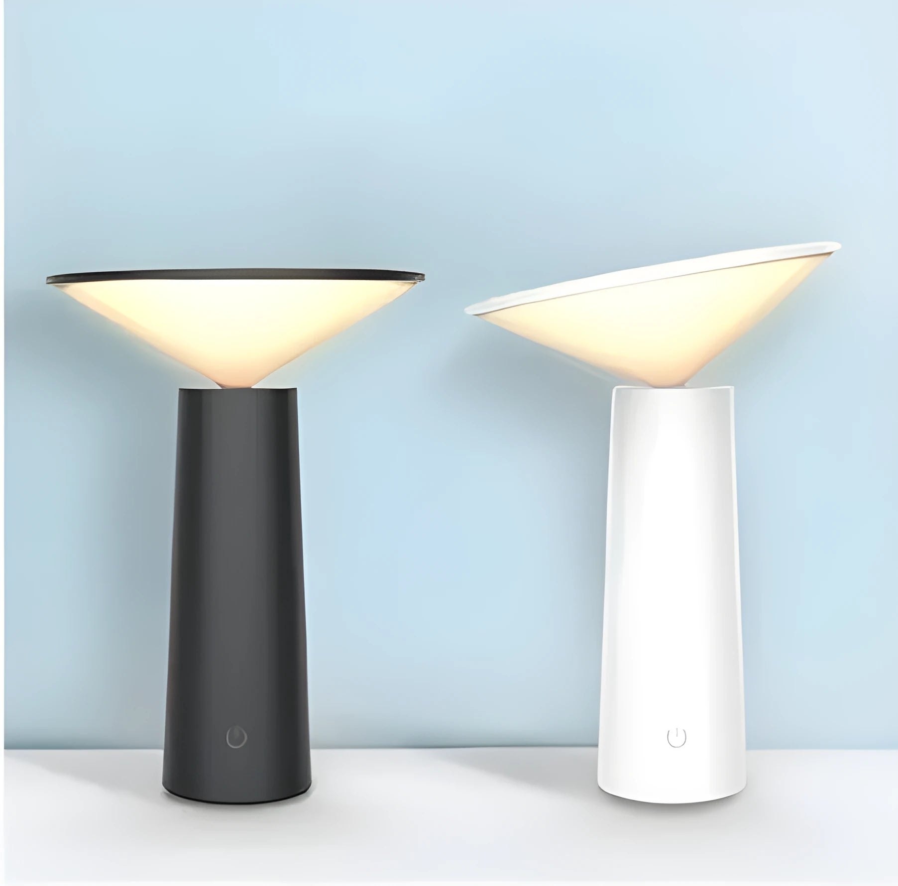 Black USB rechargeable desk lamp with touch sensor base and a tilted lamp head on a wooden desk.
